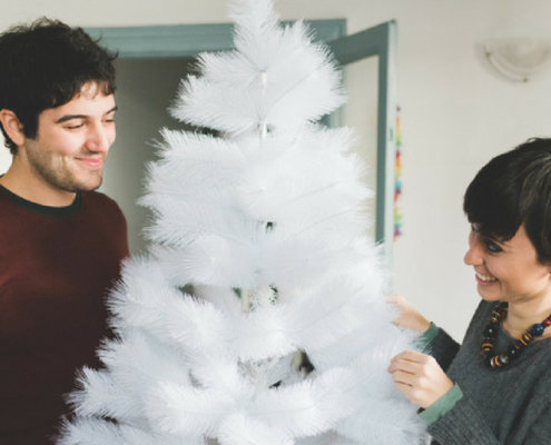 Mudarse en Navidad: Pareja decorando arbol Navidad